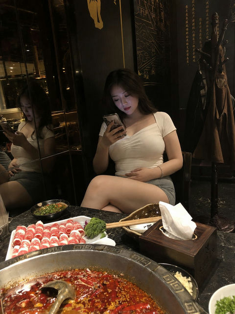 四川火锅店玩手机的中国年轻女子 - AI图片提示词示例